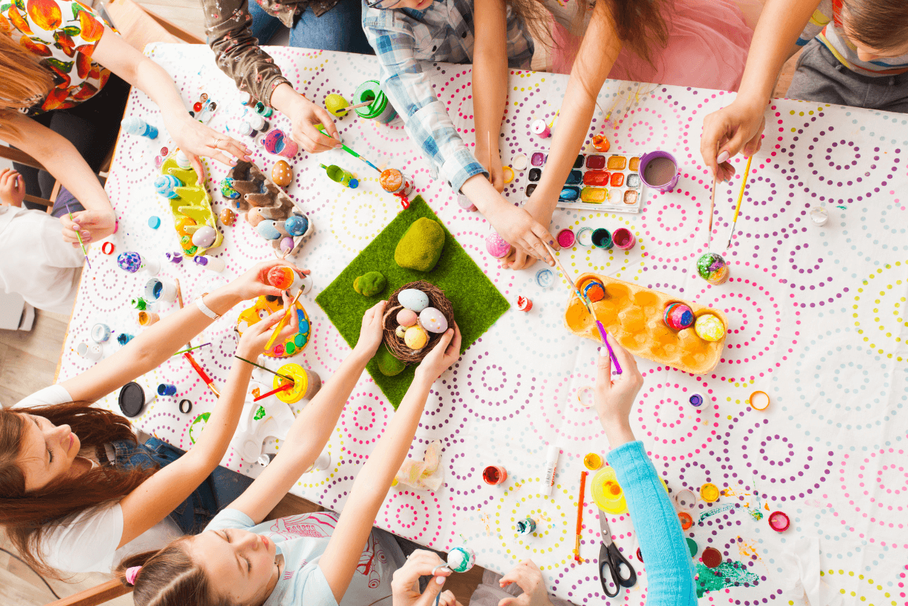 A bird's eye view of people working on crafts around a table. 