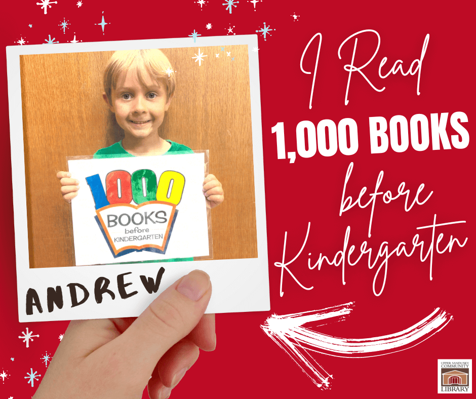 Young boy holding a sign that says he completed the 1,000 books before Kindergarten program.