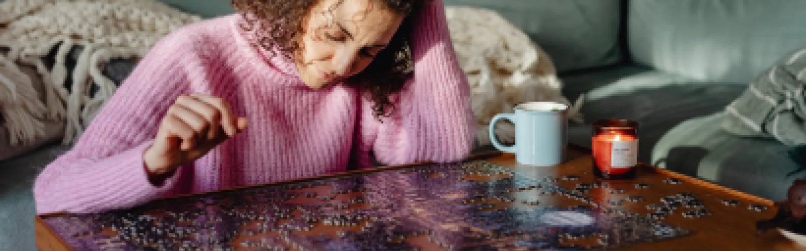 A woman working on a jigsaw puzzle. 