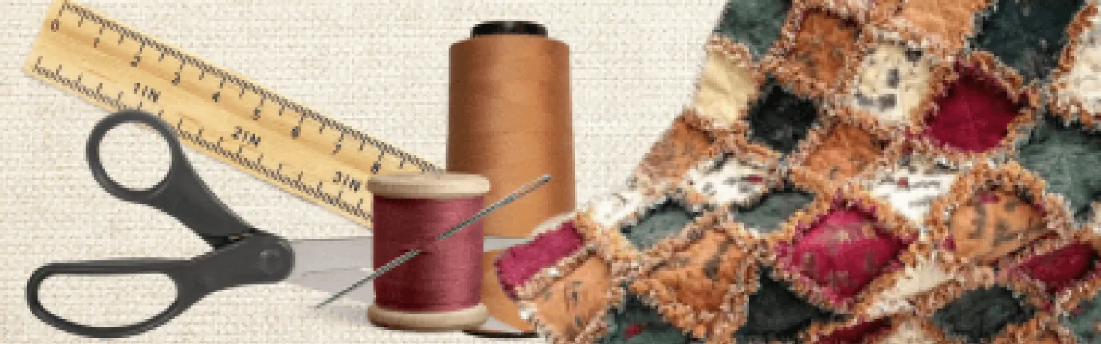 A rag quilt, thread and needle, scissors, and a ruler. 