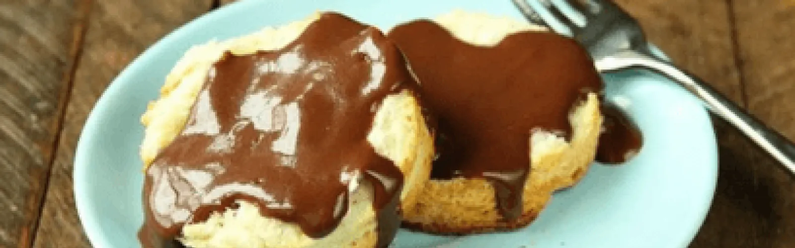 Biscuits with gravy on a plate. 